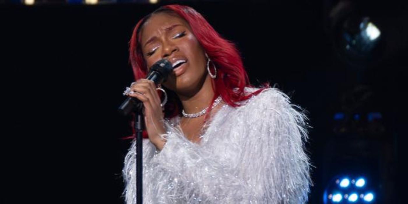 'American Idol' hopeful Madai Chakell sings on stage wearing a white furry top