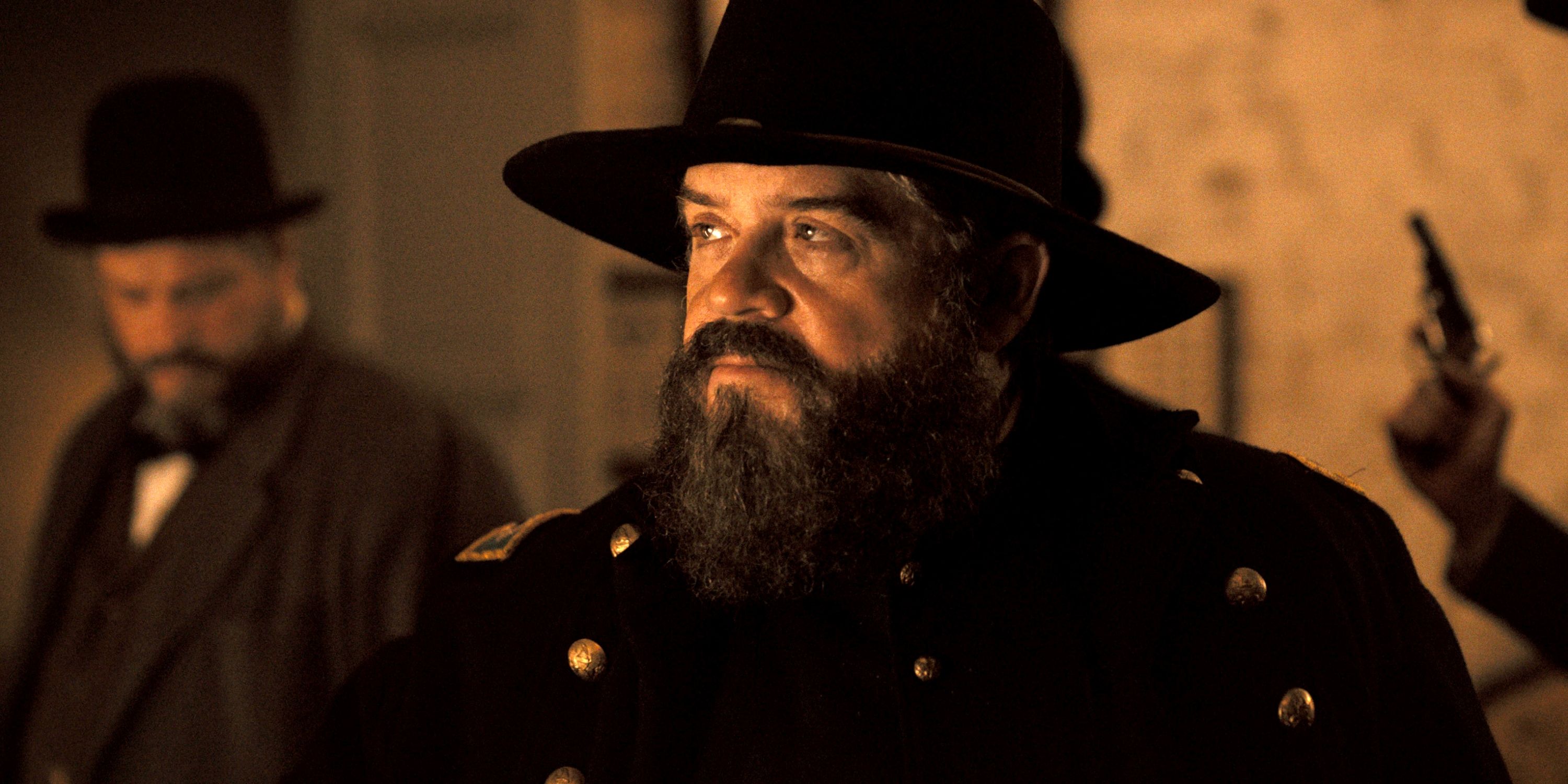 Patton Oswalt as Detective Lafayette Baker looking off to the side in Episode 4 of Apple TV+'s Manhunt