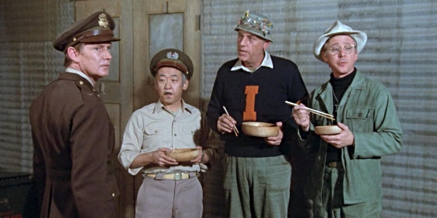 Capt. Sam Pak (Pat Morita), Father Francis Mulcahy (William Christopher), Michael Harper (Dennis Robertson), and Henry Blake (McLean Stevenson) on M*A*S*H