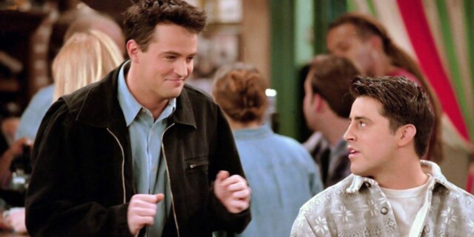 Chandler Bing (Matthew Perry) standing behind Joey Tribianni (Matt LeBlanc)in Friends