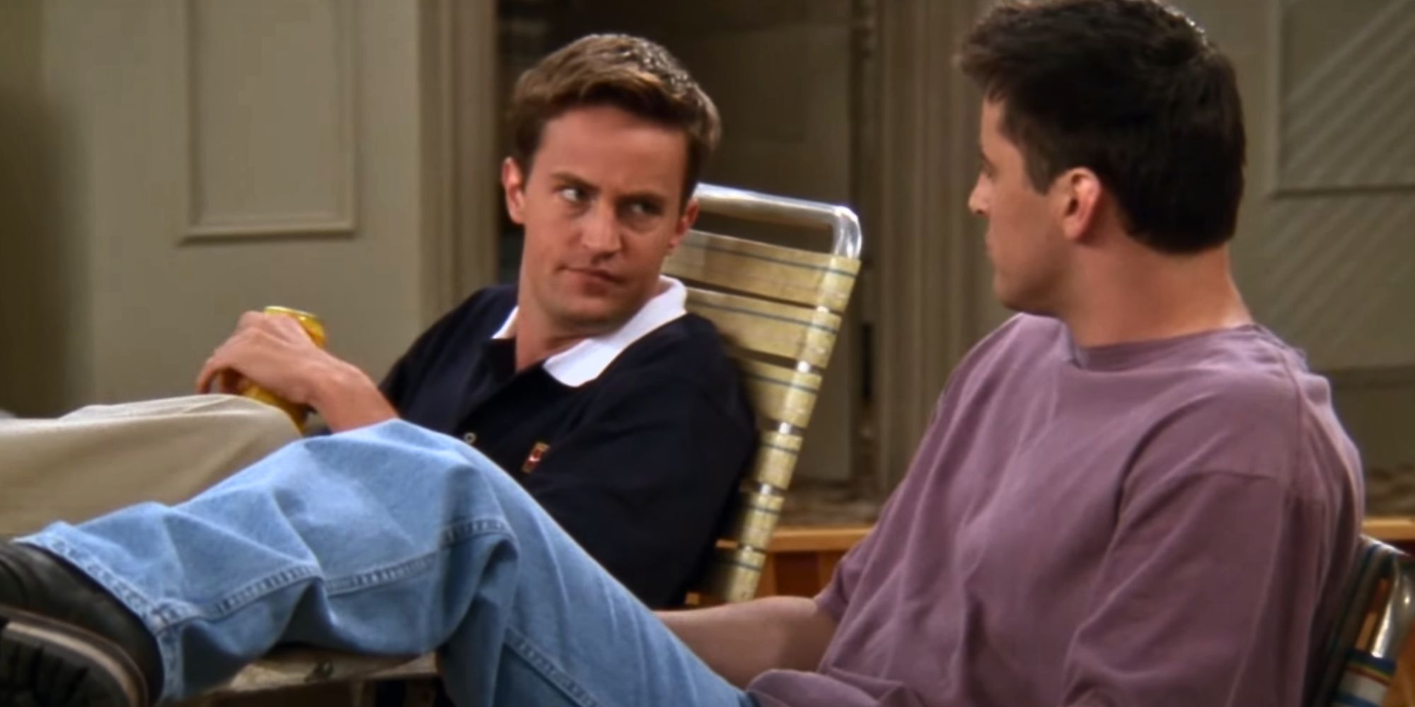 Chandler Bing sitting and looking at Joey Tribbiani in Friends