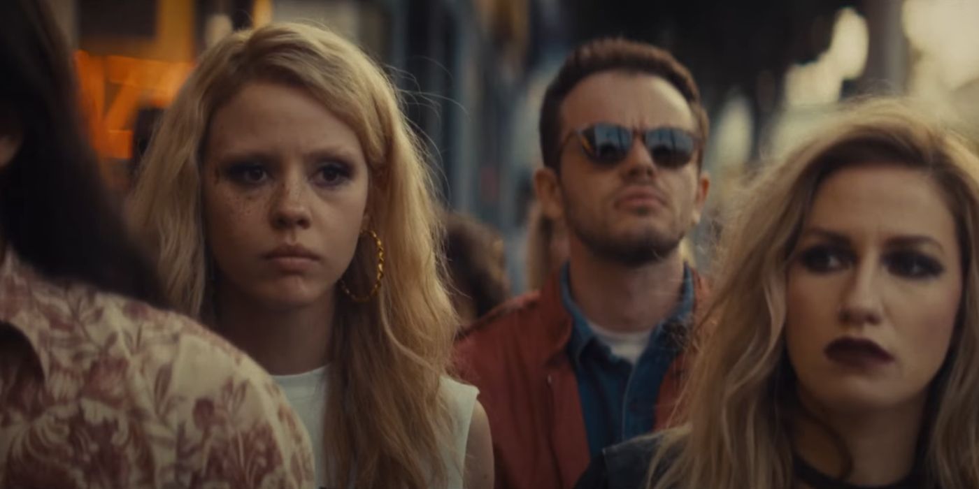 Mia Goth as Maxine Minx, standing with a concerned crowd in Maxxxine.