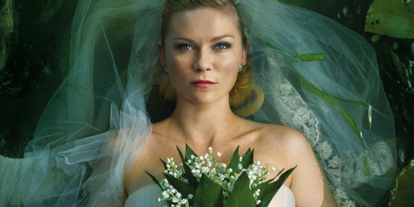 Justine wearing a wedding dress and holding a bouquet of white flowers