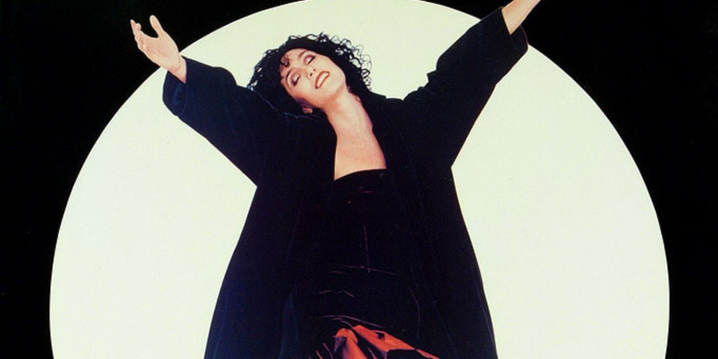 Cher as Loretta Castorini raising her arms and smiling with the moon in the background in a poster for Moonstruck