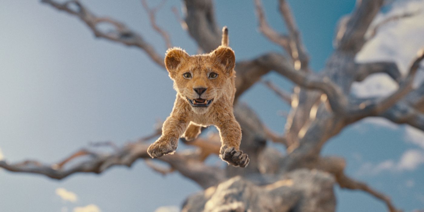 Baby Mufasa jumping from a tree and smiling giddily in Mufasa: The Lion King.