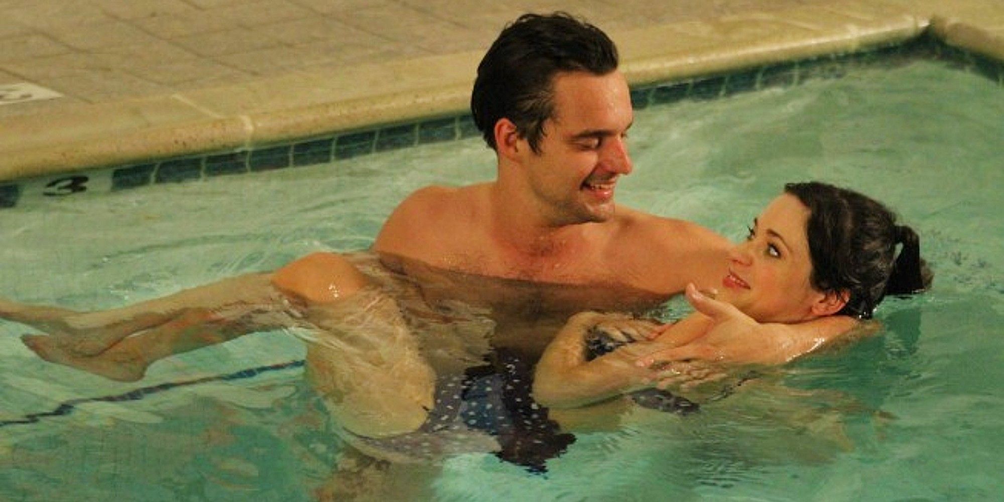 Nick Miller holding Jess Day in a swimming pool in New Girl