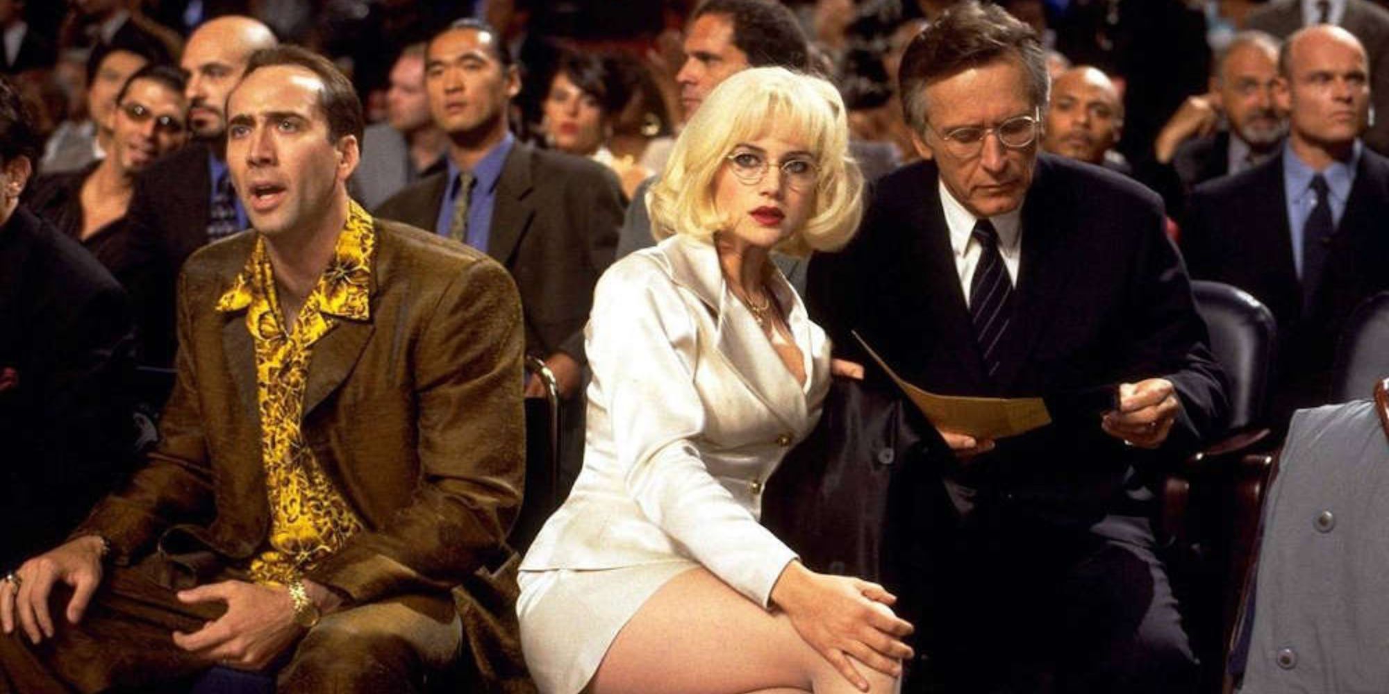 Nicolas Cage and Carla Gugino watch the offscreen boxing match Joel Fabiani reads a paper in Snake Eyes