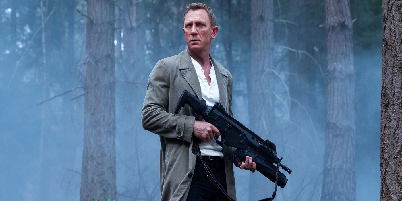 Daniel Craig as James Bond holding a gun in No Time to Die