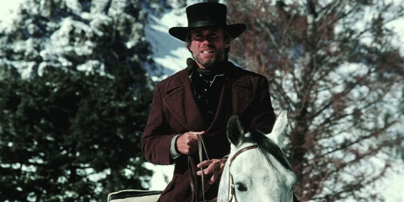 The Preacher (Clint Eastwood) rides through the snow on horseback in 'Pale Rider.'