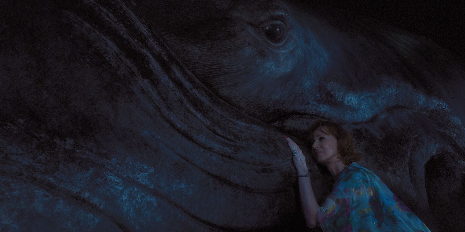 Evelyn (Allison Janney) sitting next to a beached whale in Palm Royale