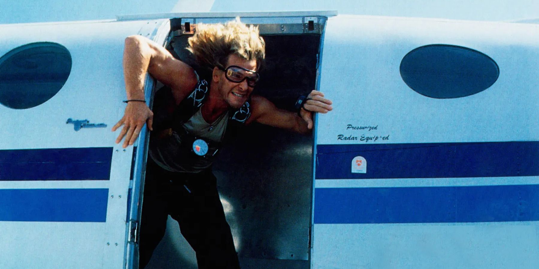 Bodhi getting ready to jump out of plane, wearing goggles, in 'Point Break'