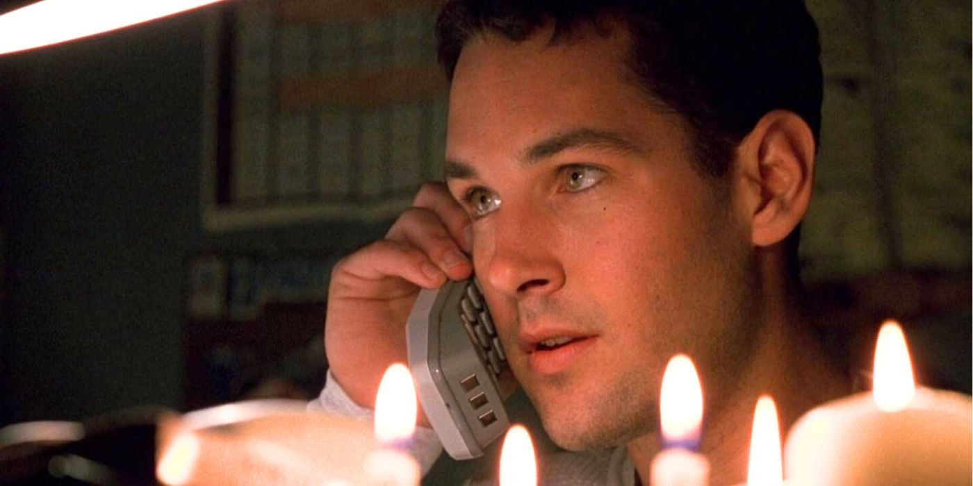 Paul Rudd as Tommy Doyle talking on the phone with candles around him in Halloween: The Curse of Michael Myers