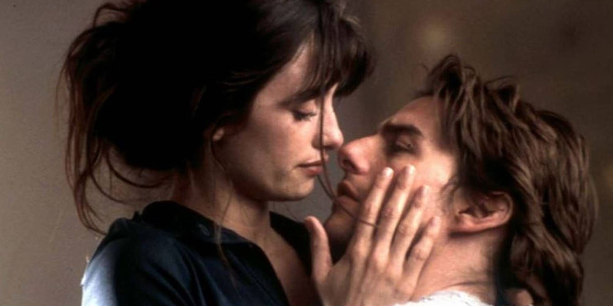 Penélope Cruz as Sofia caressing Tom Cruise as David's face while he looks up at her in Vanilla Sky.