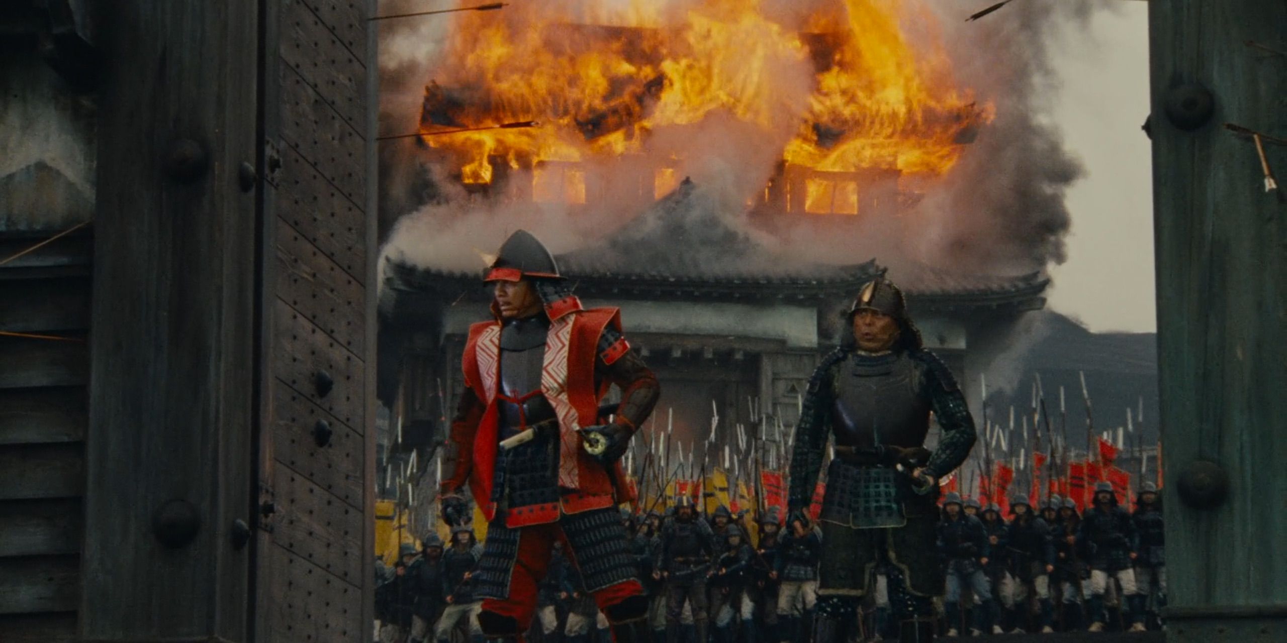 Ran - Jiro (Jinpachi Nezu) stands before a castle, in flames