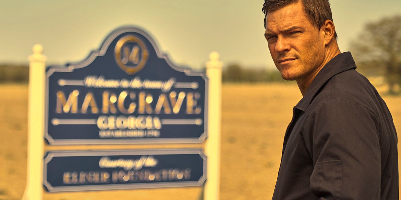 Reacher looking to the distance with a town sign in the background in Reacher.