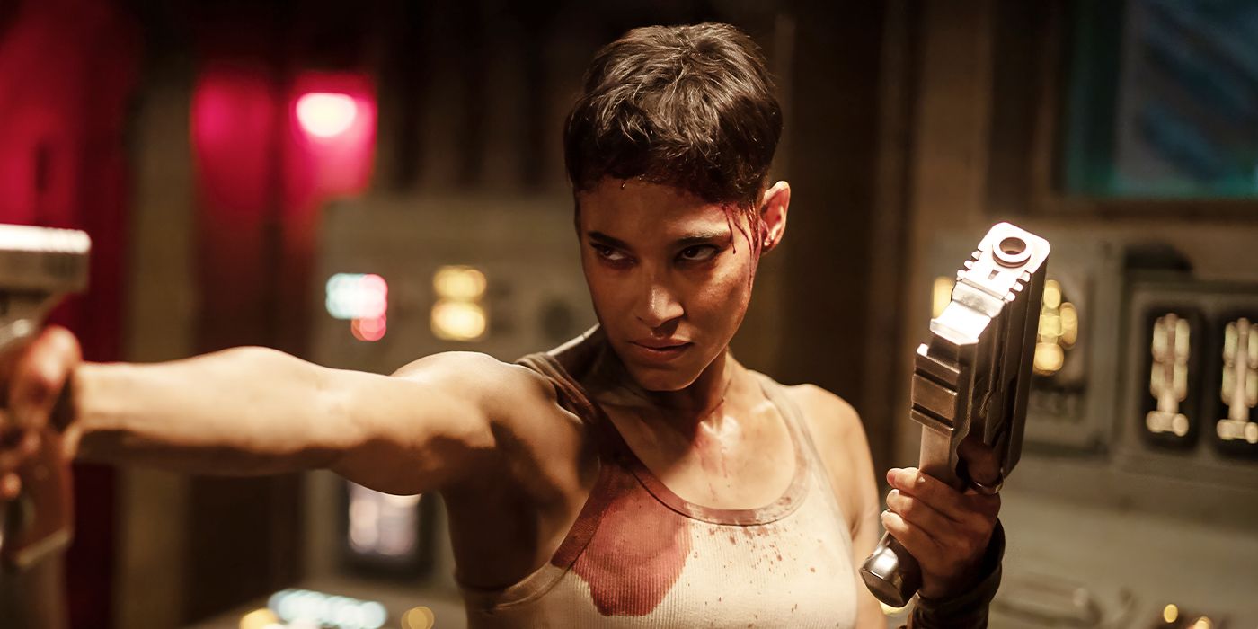 Sofia Boutella as Kora holding two guns in Rebel Moon - Part Two: The Scargiver. 