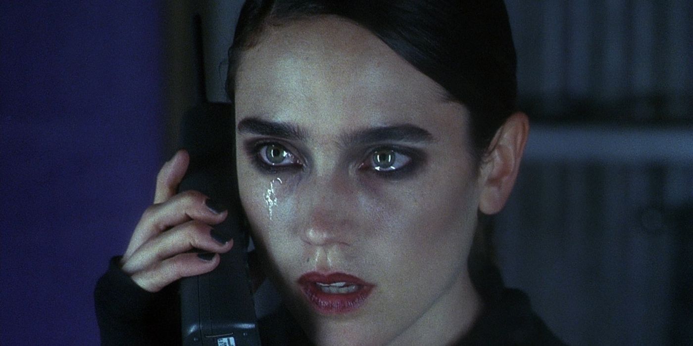 Marion talks on the phone, her face and eyes wet with tears