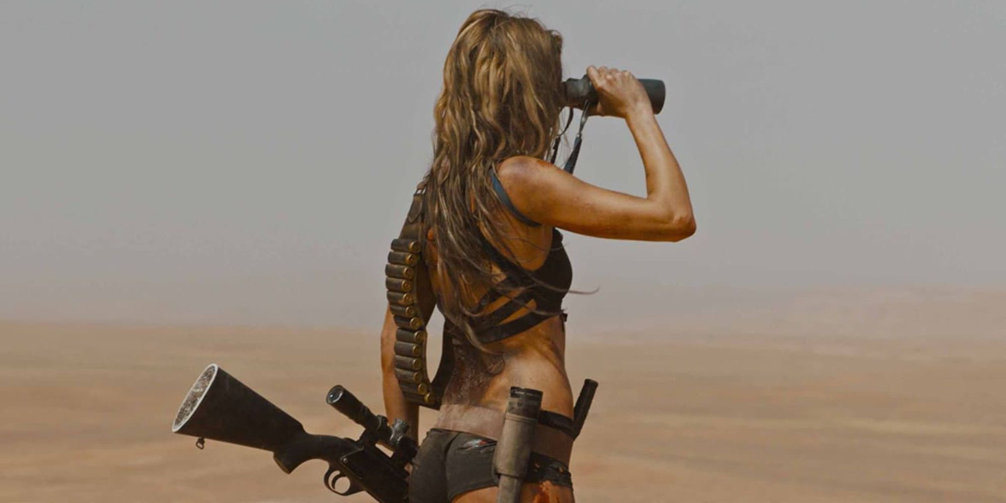 A woman in the desert using binoculars in Revenge - 2017 (2)