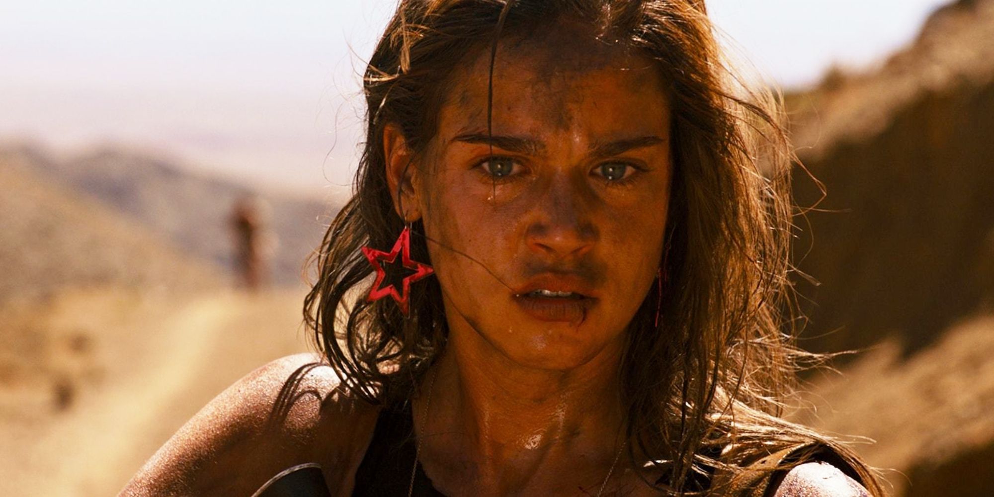 A woman with dirt on her face looking emotional in Revenge - 2017 (3)