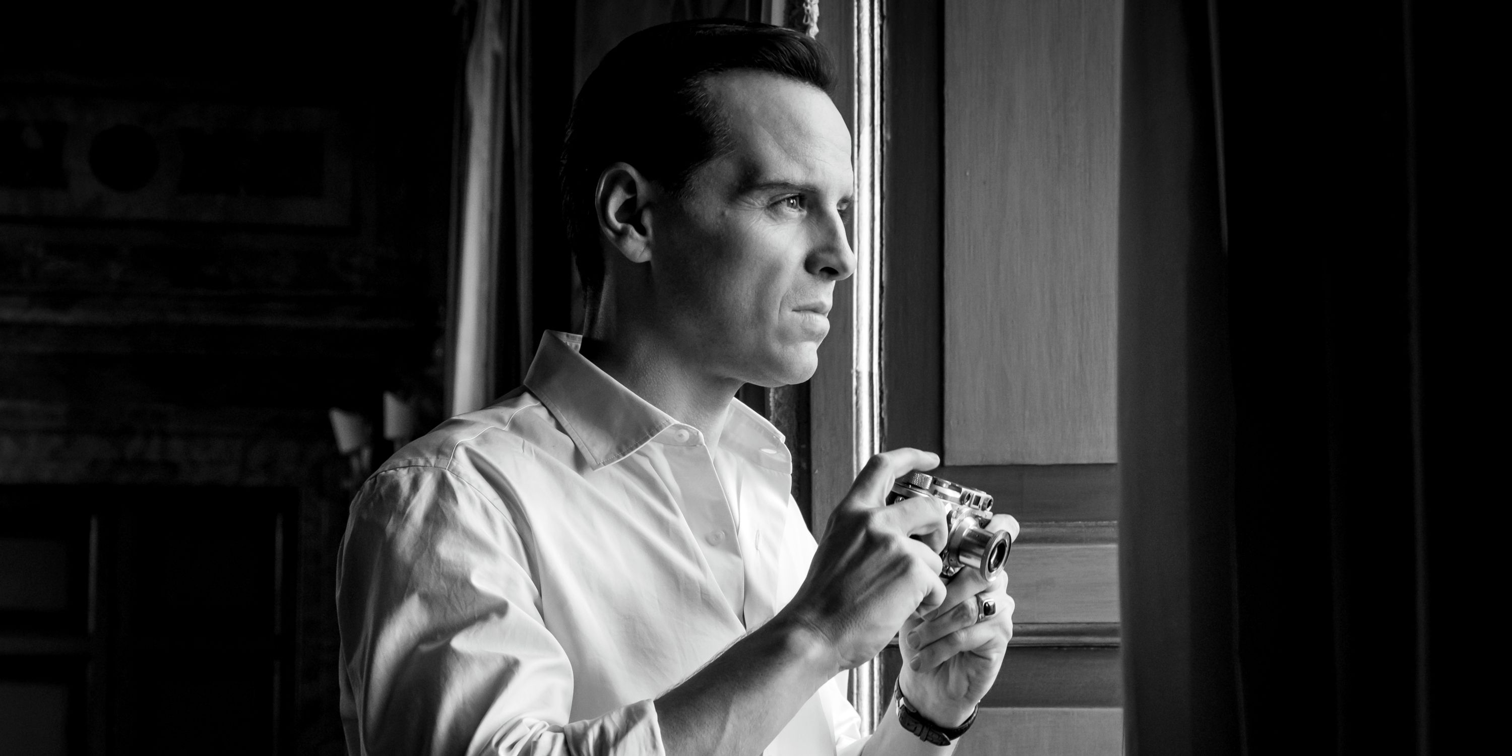 Andrew Scott as Tom Ripley looking out the window in Episode 4 of Netflix's Ripley