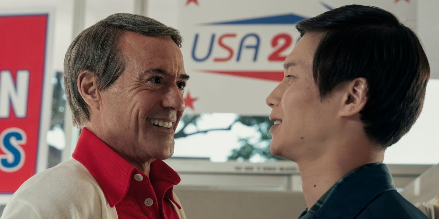 Robert Downey Jr smiling as a shady politician at Hoa Xuande&rsquo;s the Captain in The Sympathizer.