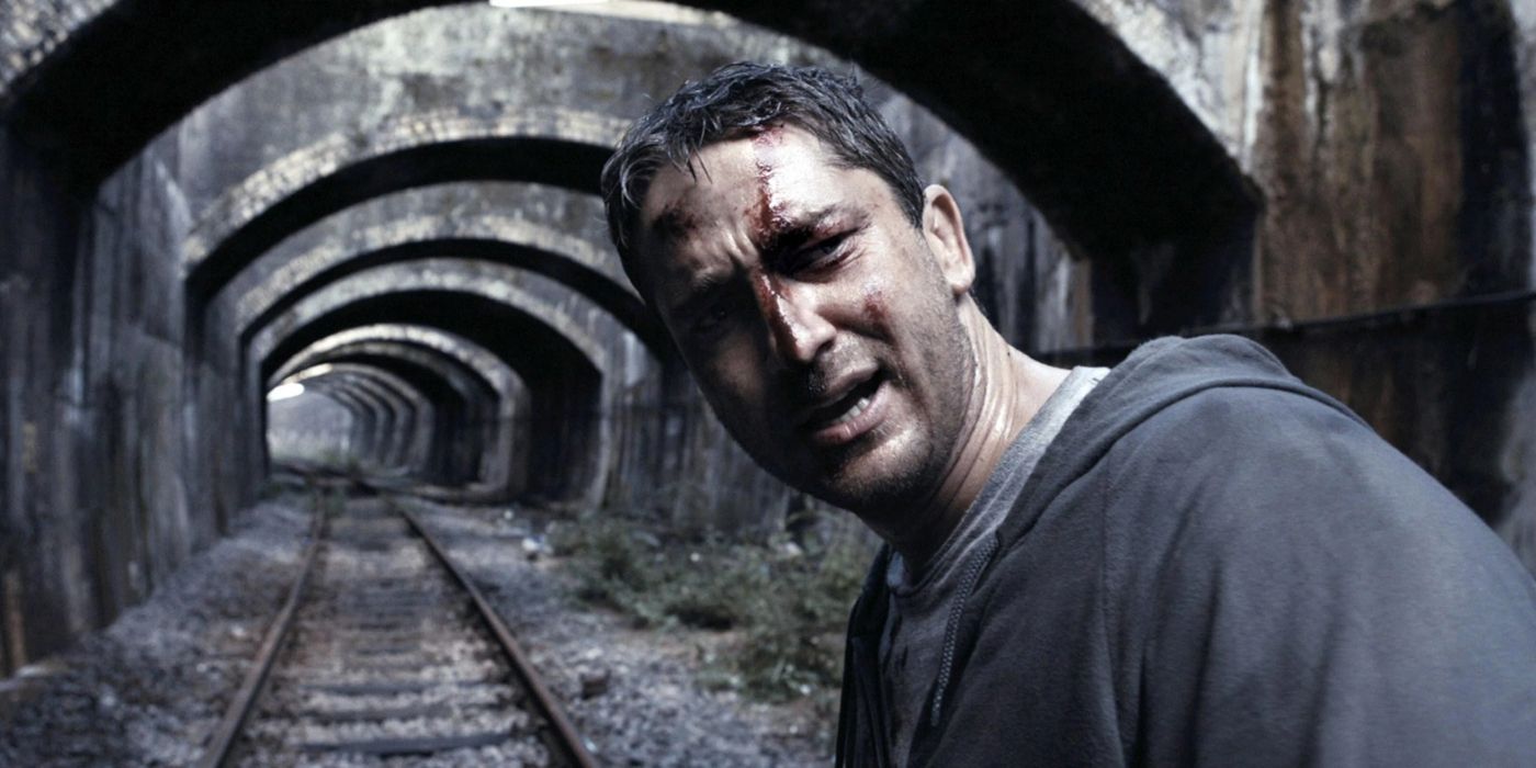 One Two (Gerard Butler) stands in an abandoned subway tunnel with a bloodied face in 'RocknRolla' (2008).