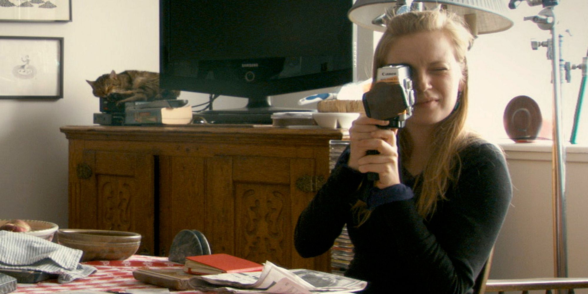 Sarah Polley with a camera pointing at the camera in her film 'Stories We Tell' (2012)