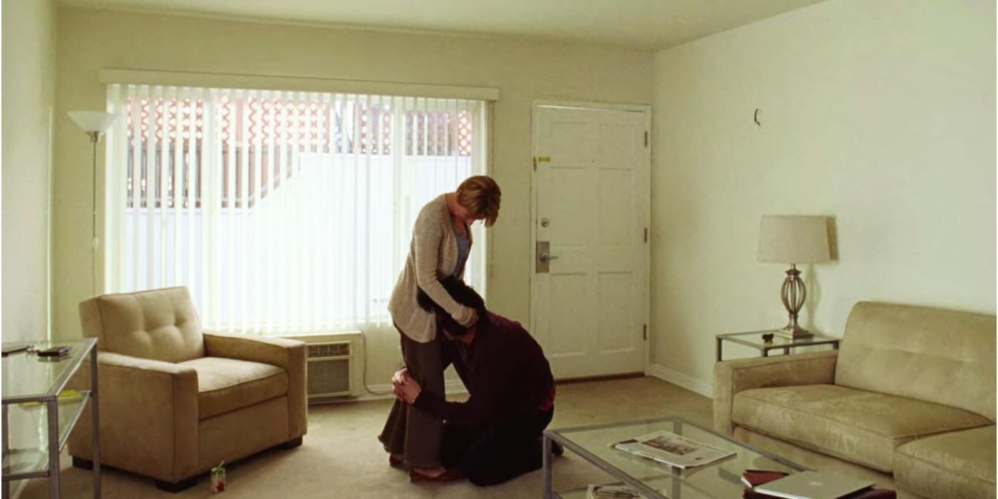 Scarlett Johansson holding Adam Driver's head as he kneels in front of her in 'Marriage Story' scene