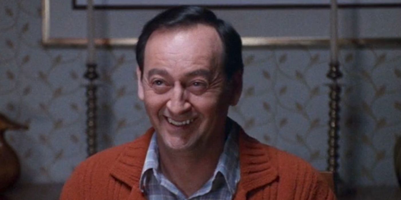 Joe Flaherty as Harold Weir smiling in orange sweater in 'Freaks and Geeks'