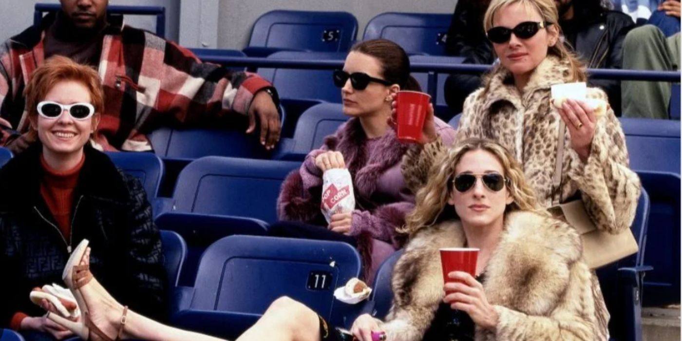 Cynthia Nixon, Sarah Jessica Parker, Kristin Davis, and Kim Cattrall on set attending a baseball game in 'Sex and the City'