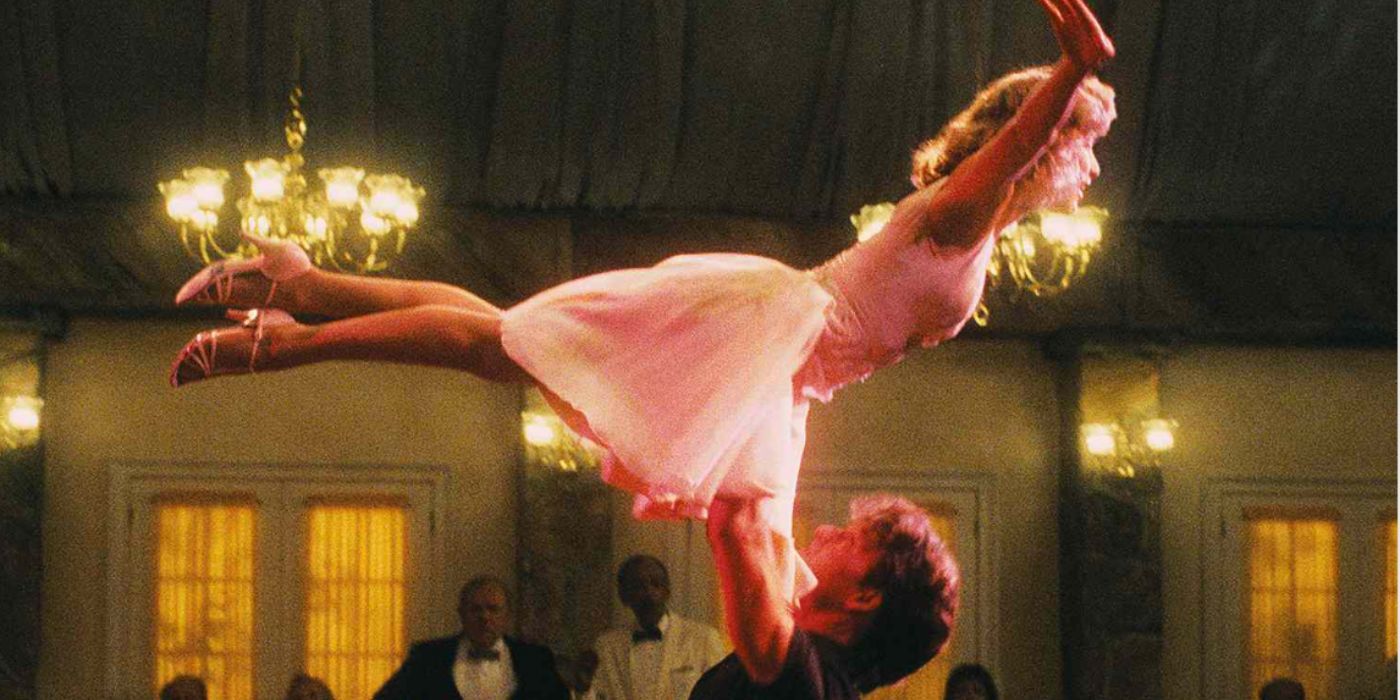 Johnny lifts Baby, in a white dress, over his head during a dance performance in &lsquo;Dirty Dancing&rsquo;