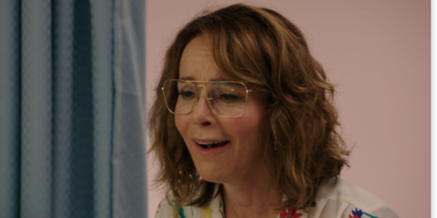 Jennifer Grey as Judy Meyers laughing wearing glasses in 'Red Oaks'