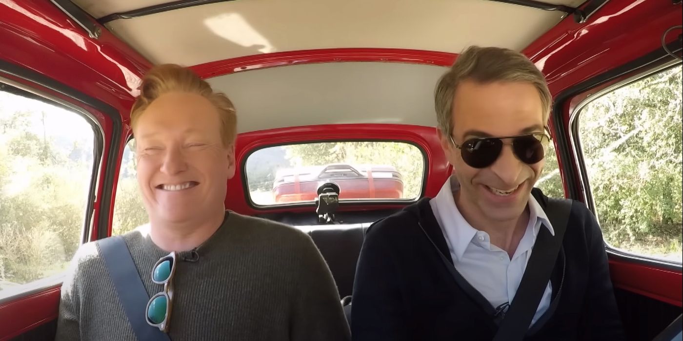 Conan O'Brien and Jordan Schlansky laughing in a car in Conan in Italy