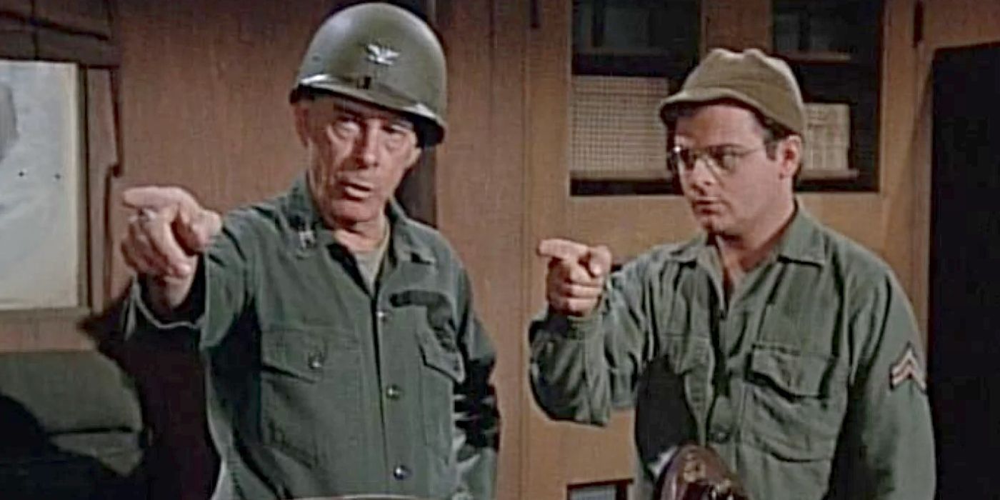 Gary Burghoff and Harry Morgan as Radar and Potter pointing at something offscreen in M*A*S*H.