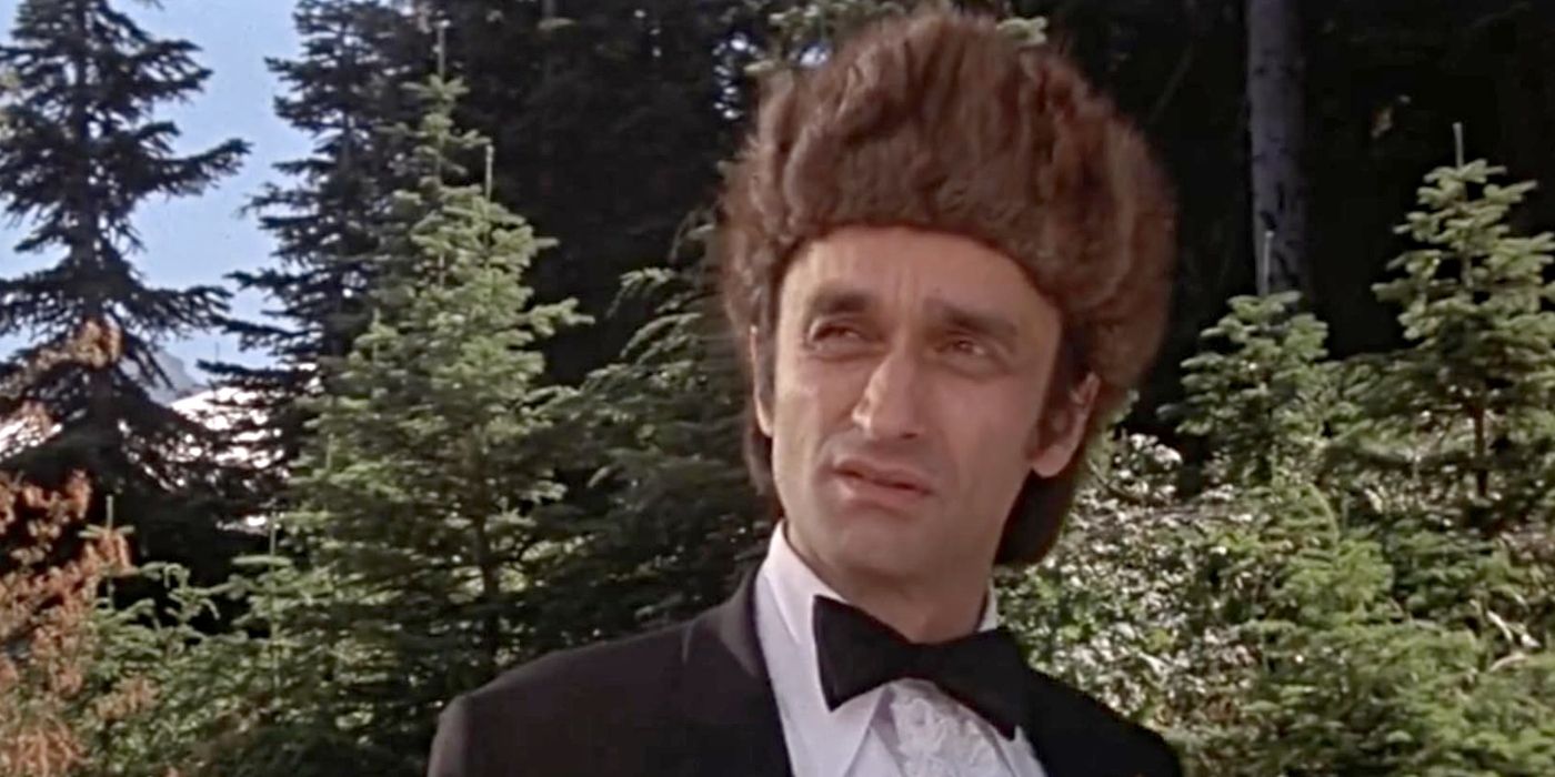 John Cazale as Stanley, standing in the woods wearing a tuxedo and a fur hat in The Deer Hunter