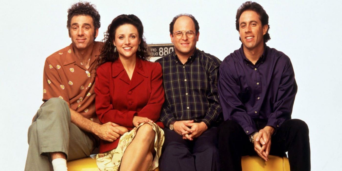 From left to right: Kramer, Elaine, George, and Seinfeld, sitting on a bench against a white backdrop.
