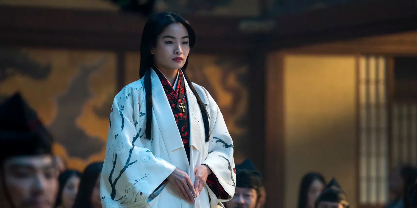 Mariko (Anna Sawai) standing in the Council of Regents room and looking ahead to the right in Shogun