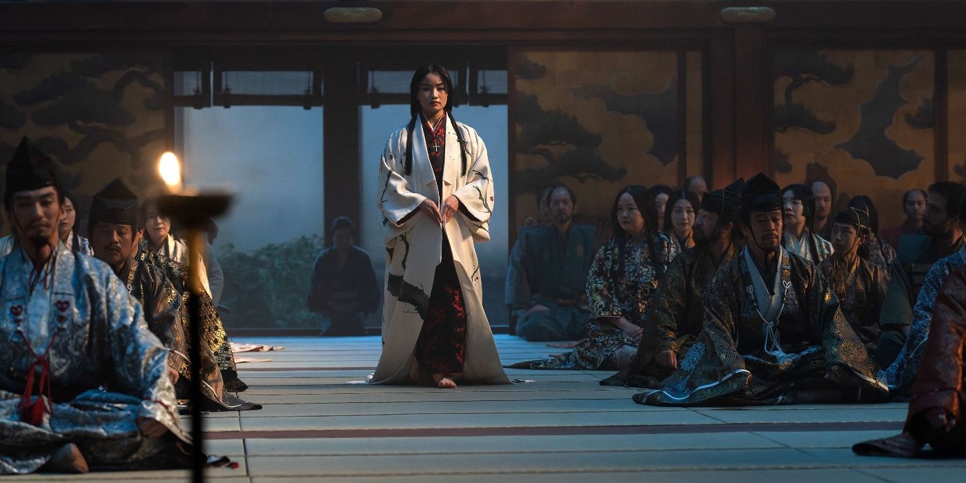 Anna Sawai walking among rows of seated vassals in Shogun Episode 9