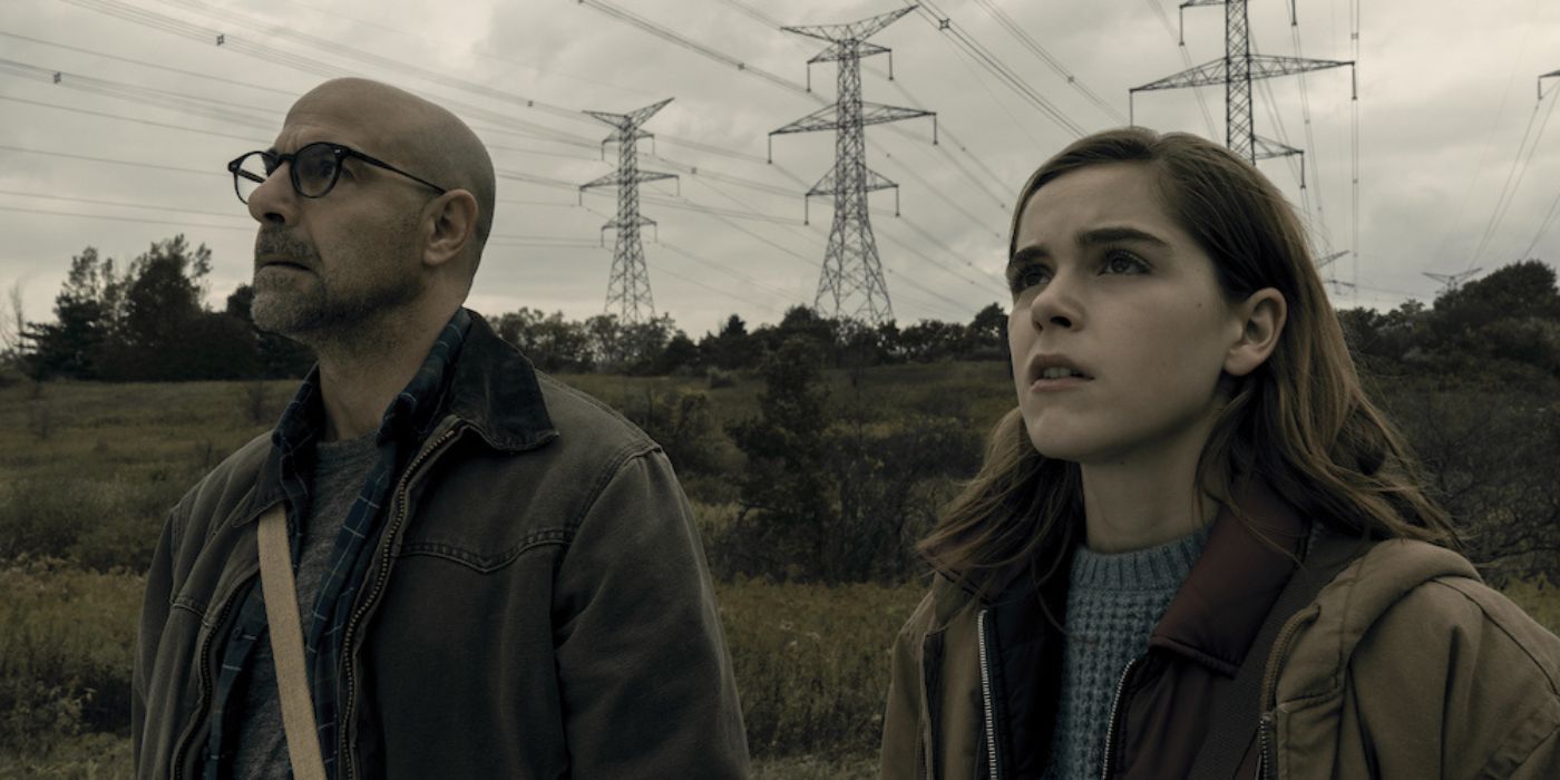 Stanley Tucci and Kiernan Shipka looking concerned at something offscreen in The Silence.