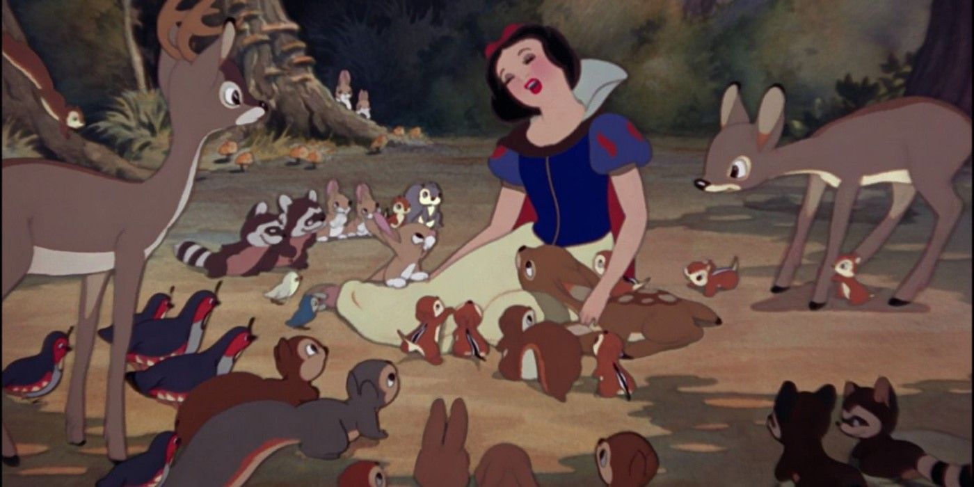 Snow White sits in the forest, surrounded by the woodland creatures in 'Snow White and the Seven Dwarfs'