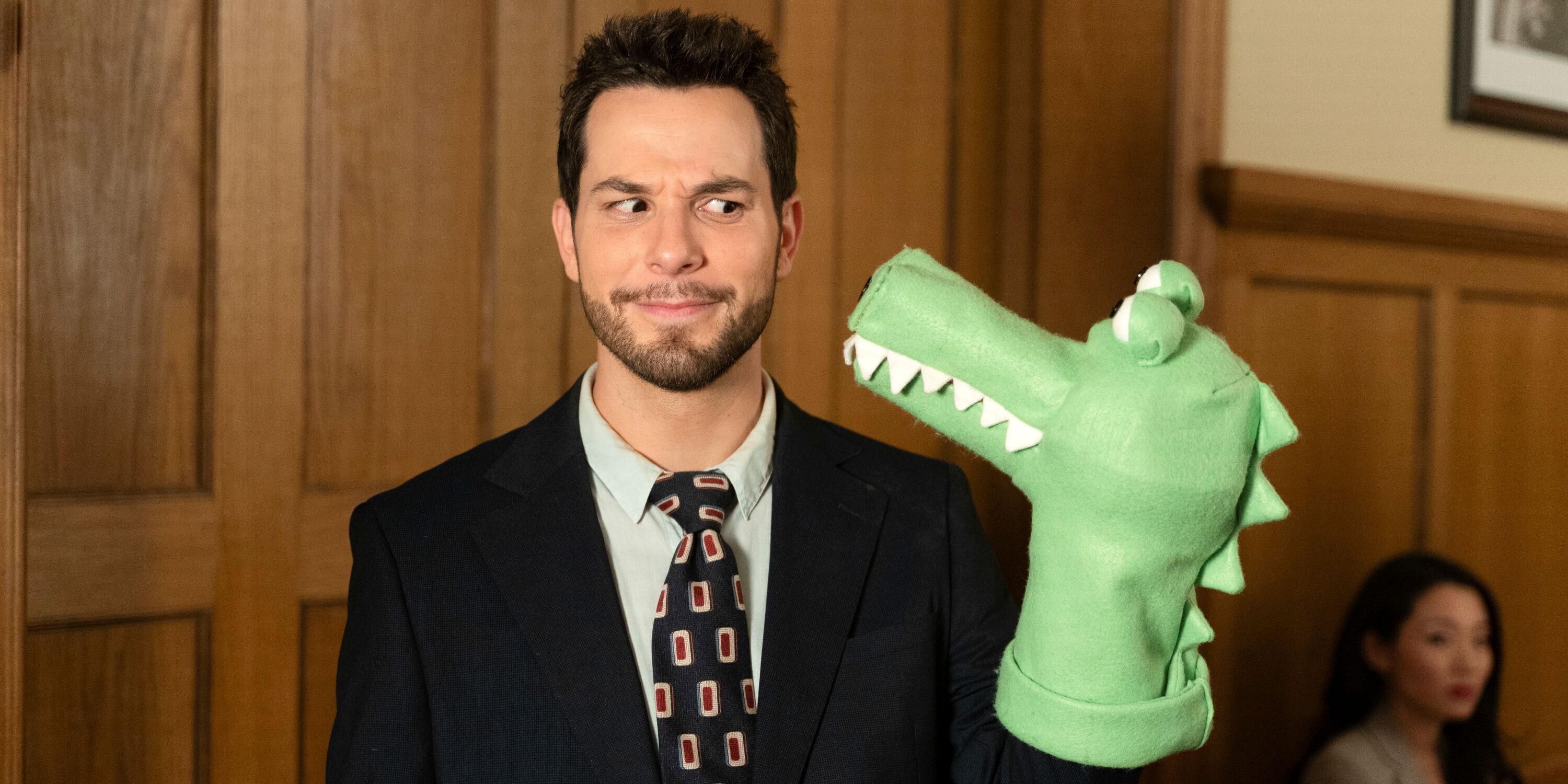 Skylar Astin as Todd looking at a dinosaur puppet in Episode 2 of Season 2 of CBS' So Help Me Todd