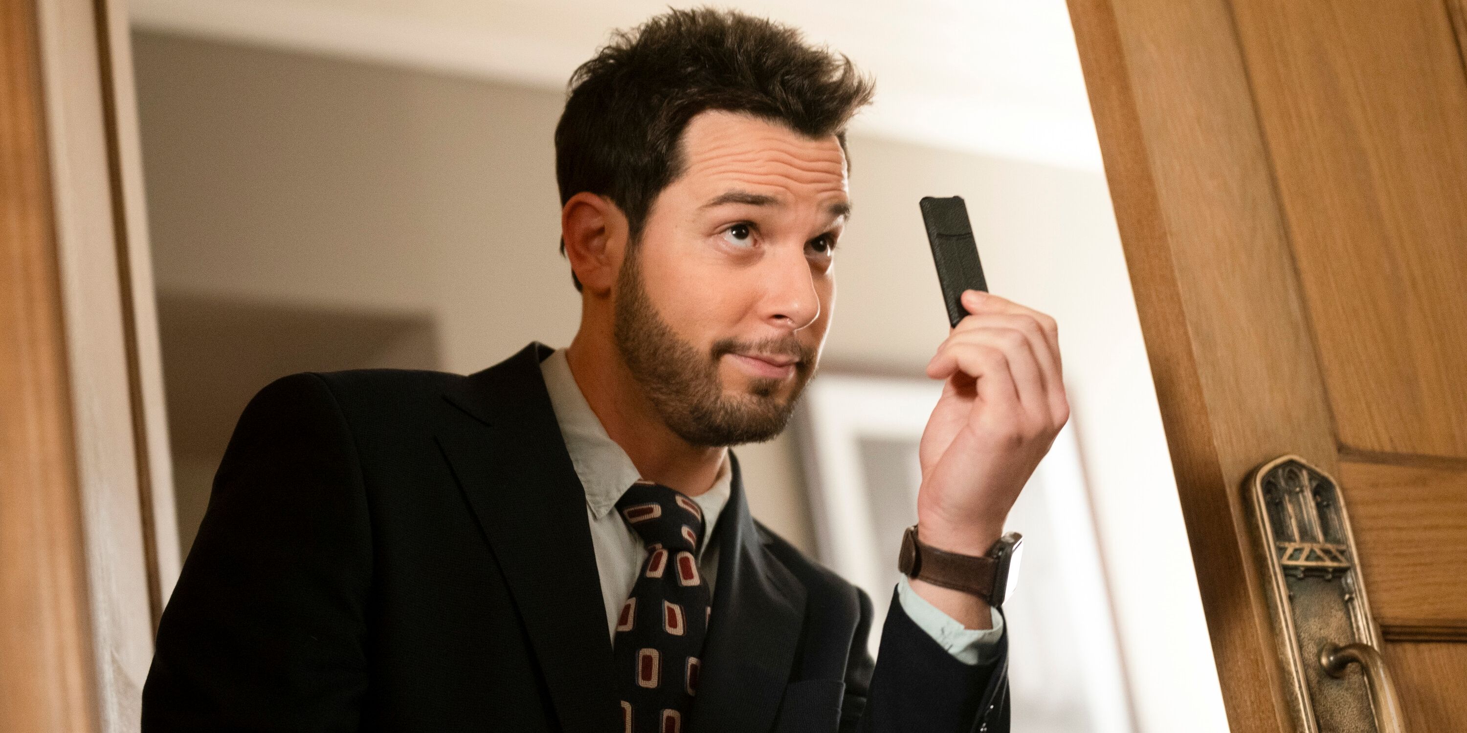 Skylar Astin as Todd holding something up in Episode 2 of Season 2 of CBS' So Help Me Todd