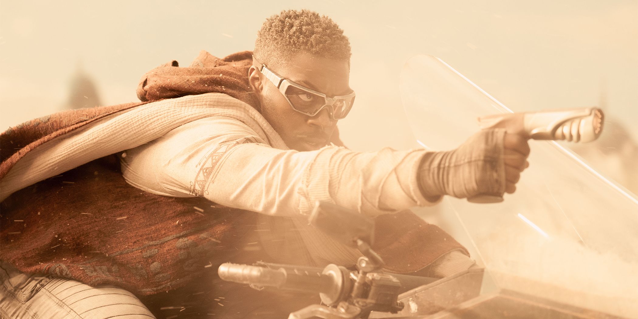 David Ajala as Book racing on a sand runner holding up a weapon in Star Trek: Discovery Season 5