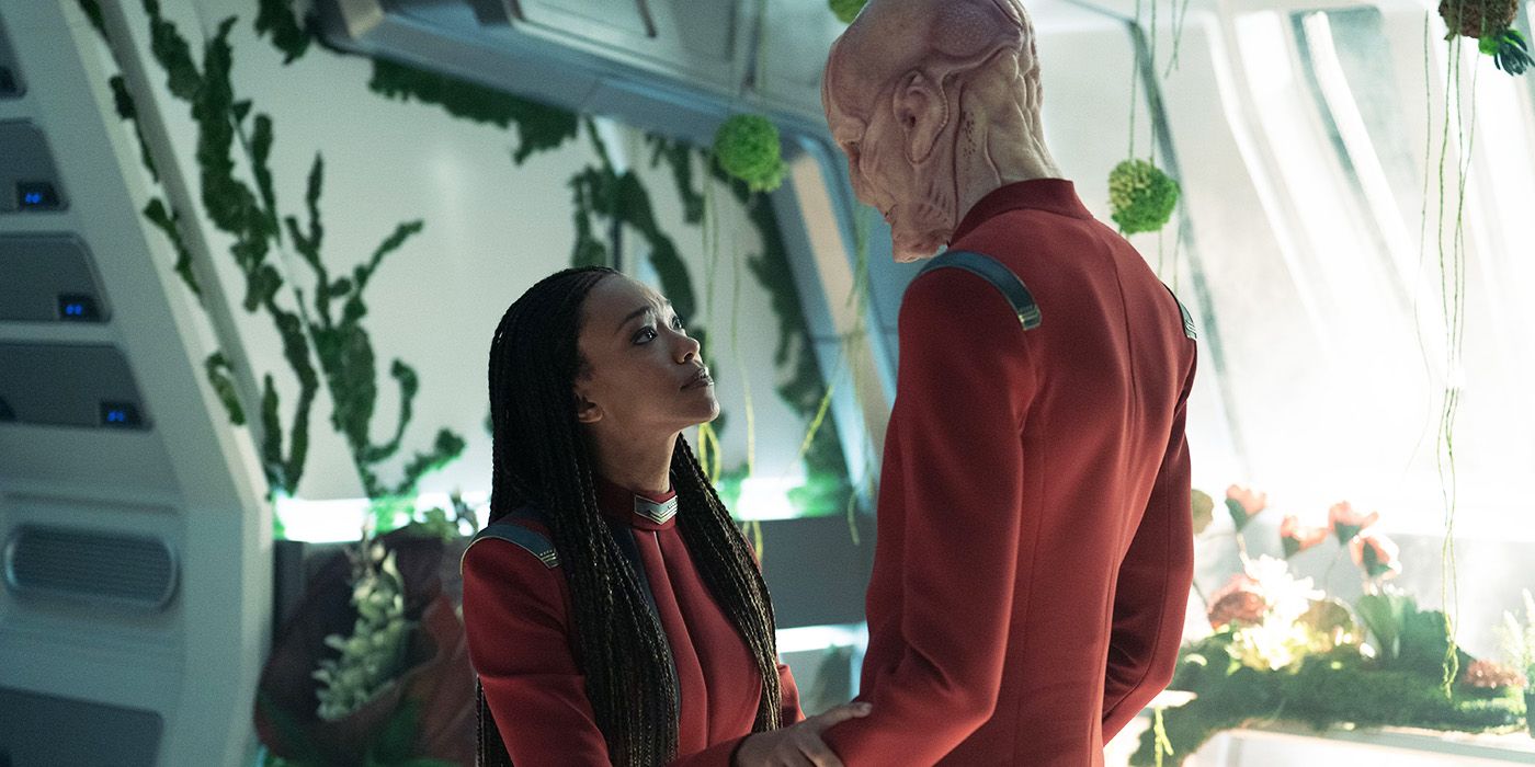 Sonequa Martin-Green and Doug Jones facing each other in a room full of plants in Star Trek: Discovery Season 5