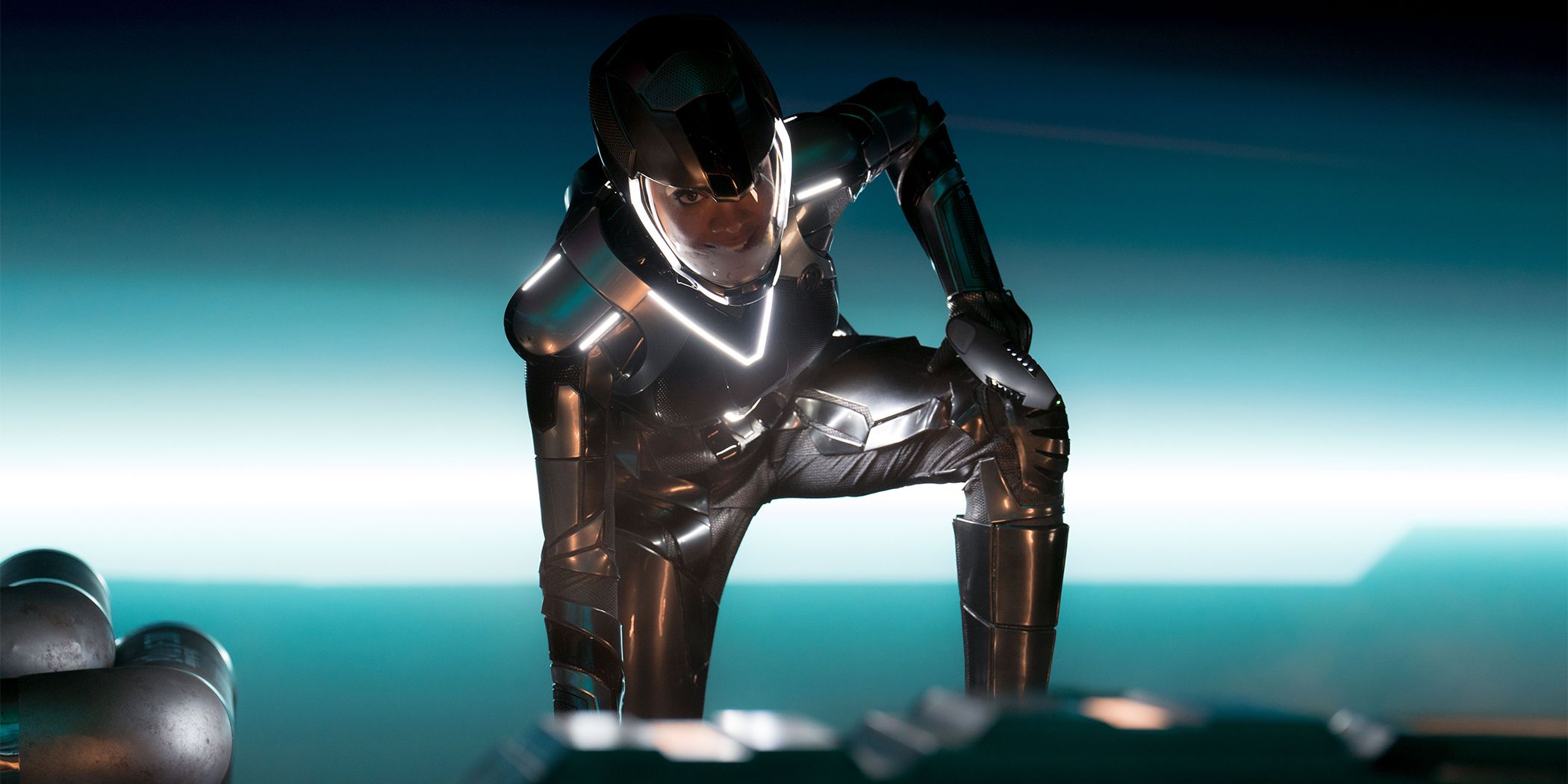 Sonequa Martin-Green as Michael Burnham in a silver suit crouching over in Star Trek: Discovery Season 5