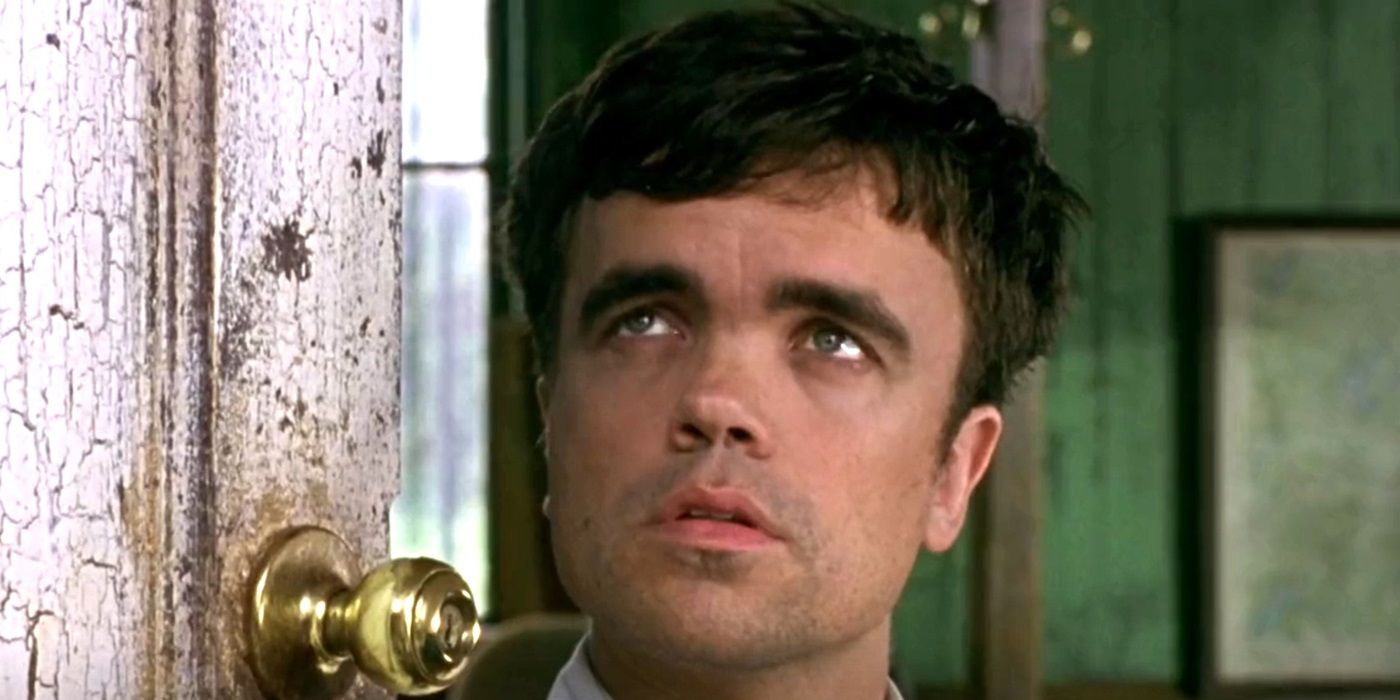 Peter Dinklage looking up at a person offscreen in The Station Agent