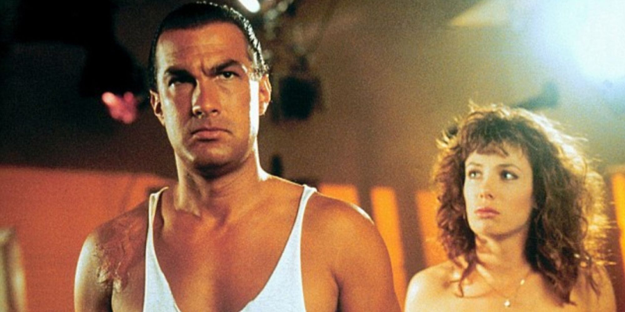 Kelly LeBrock stands behind, looking at Steven Seagal in Hard to Kill (1990)