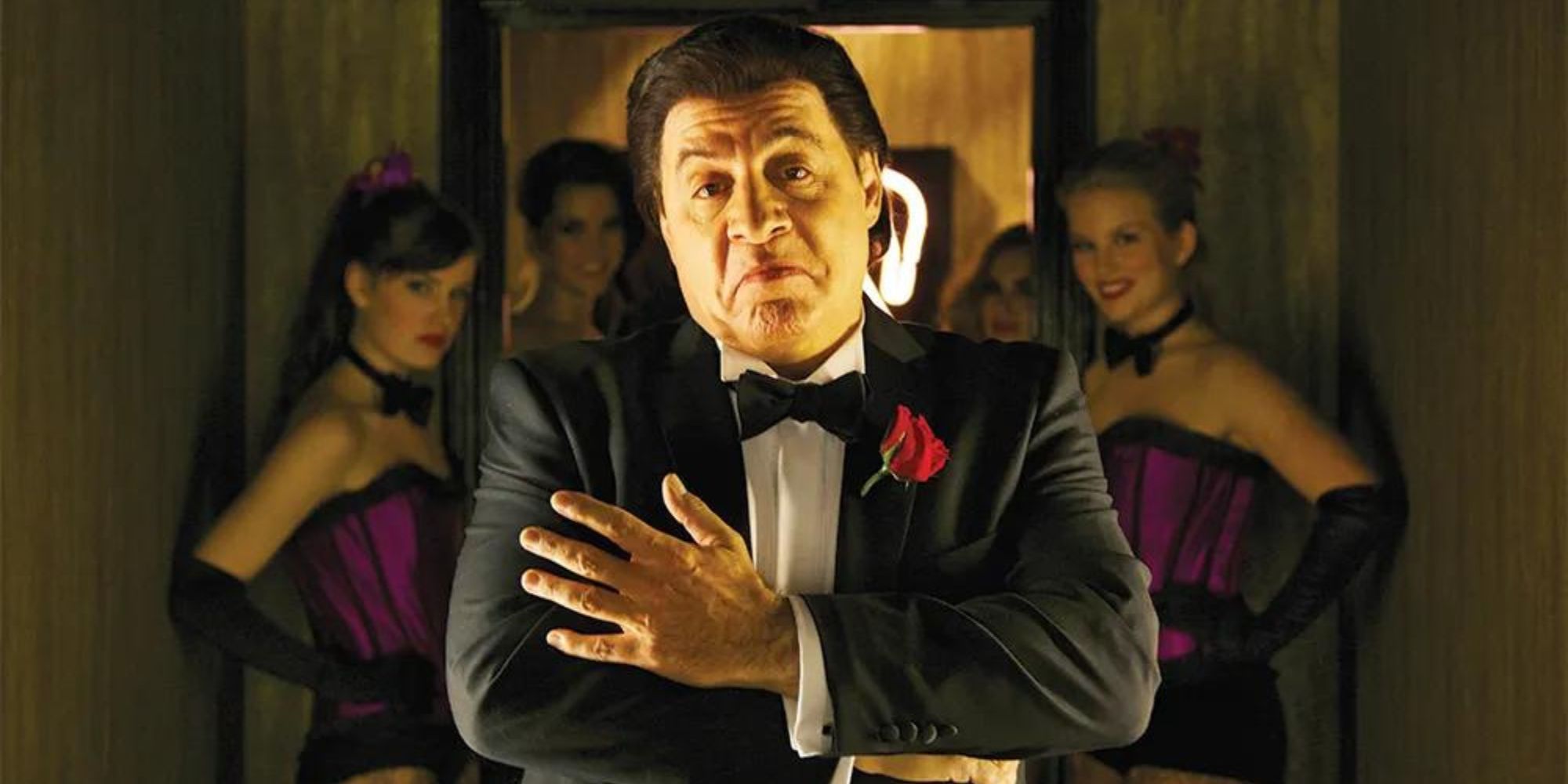 Steven Van Zandt as Frank Tagliano standing in front of several women in Lilyhammer