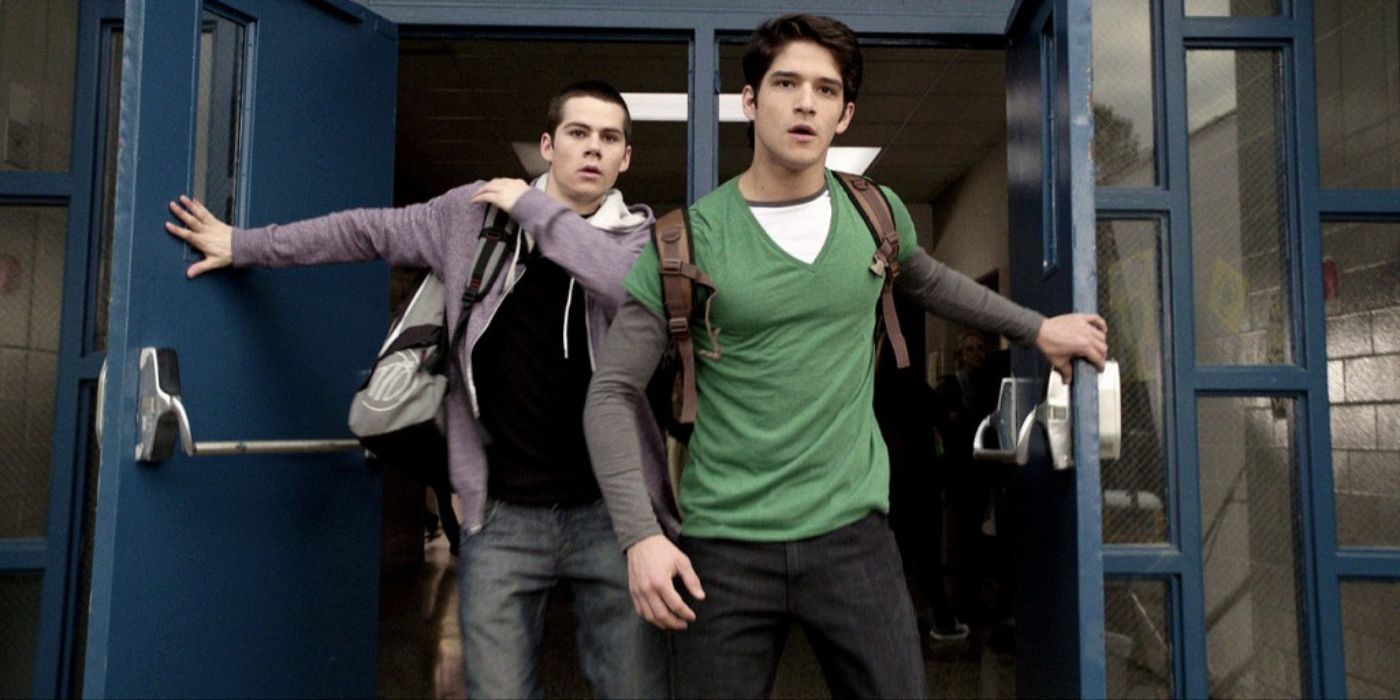 Tyler Posey and Dylan O'Brien walking through the double doors of their high school in Teen Wolf