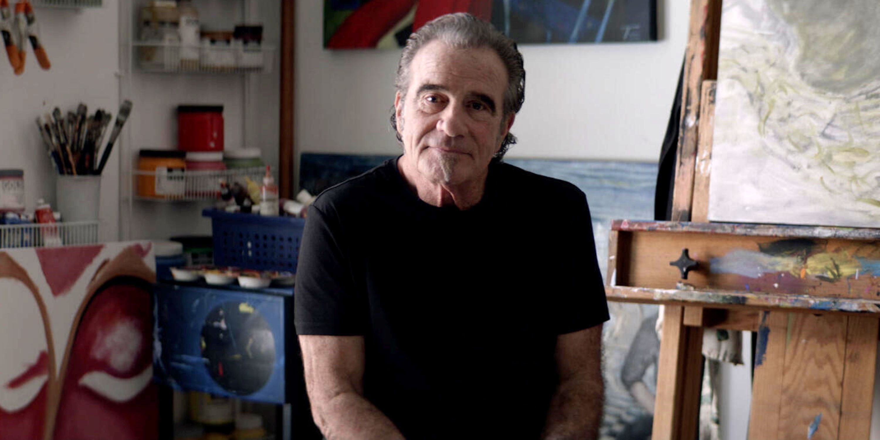 Bon Jovi drummer Tico Torres sitting and looking into the camera in the documentary Thank You, Goodnight